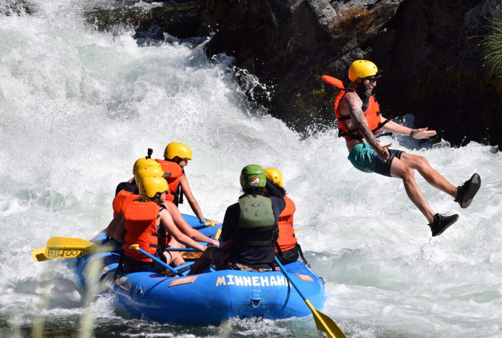 person jumping off of a raft