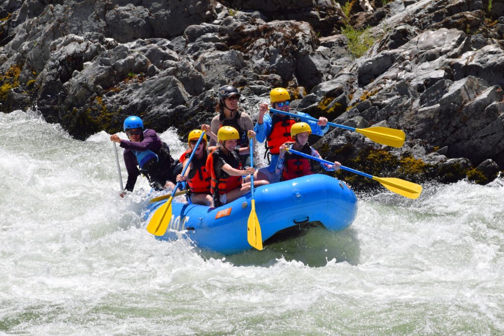 group of people fighting the rapids on the river