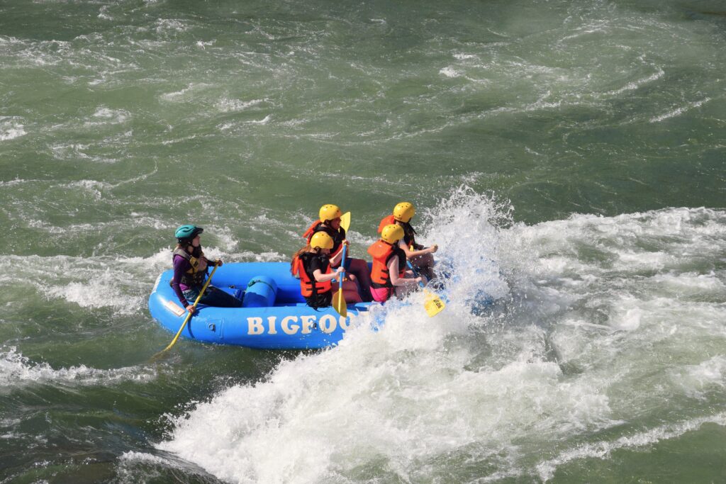 Action shot of a raft going into the rapids